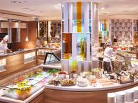 a restaurant with chefs preparing food in a kitchen at Miyako Hotel Kyoto Hachijo in Kyoto