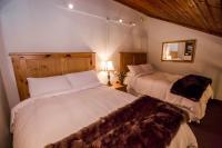 a bedroom with two beds and a mirror at Kandahar Lodge at Whitefish Mountain Resort in Whitefish