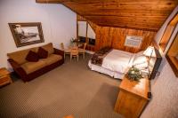 a bedroom with a bed and a couch and a table at Kandahar Lodge at Whitefish Mountain Resort in Whitefish