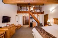 a hotel room with a bed and a staircase at Kandahar Lodge at Whitefish Mountain Resort in Whitefish