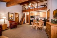 a kitchen and dining room with a table and chairs at Kandahar Lodge at Whitefish Mountain Resort in Whitefish