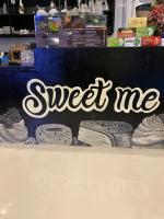 a sign that says sweet me on a counter at Sweet me homestay in Changwat Maha Sarakham