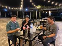 a group of three people sitting at a table with drinks at Sweet me homestay in Changwat Maha Sarakham