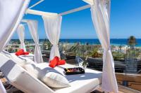 a balcony with white chairs and a view of the ocean at Sol Fuerteventura Jandia - All Suites in Morro del Jable