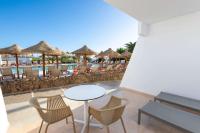 a patio with a table and chairs and a pool at Sol Fuerteventura Jandia - All Suites in Morro del Jable