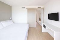 a white room with a bed and a flat screen tv at Sol Fuerteventura Jandia - All Suites in Morro del Jable