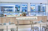 a restaurant with two tables and chairs and a buffet at Sol Fuerteventura Jandia - All Suites in Morro del Jable