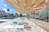 a patio with tables and chairs next to a pool at Sol Fuerteventura Jandia - All Suites in Morro del Jable