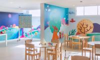 a dining room with tables and chairs and a wall mural at Sol Fuerteventura Jandia - All Suites in Morro del Jable