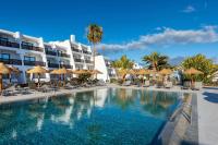 a hotel with a swimming pool with chairs and umbrellas at Sol Fuerteventura Jandia - All Suites in Morro del Jable