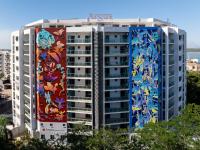 a building with a mural on the side of it at Argus Apartments Darwin in Darwin