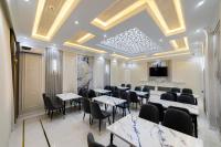 a dining room with tables and chairs and a tv at Isakhoja Boutique Hotel in Khiva