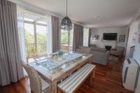 a living room with a table and a couch at Cypress Lakes Villa Domenica in Pokolbin