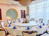 une grande table blanche avec des chaises et un grand miroir dans l'établissement Shougang Qian'an Conference Center, à Qian'an