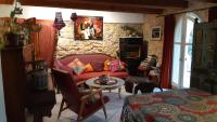 a living room with a red couch and a table at Le Mas Nomade in Callian