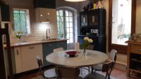 a kitchen with a table and some chairs and a sink at Le Mas Nomade in Callian