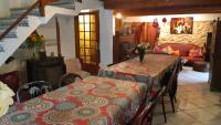 a dining room with two tables and a couch at Le Mas Nomade in Callian