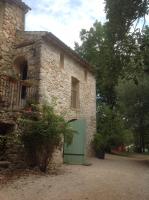 a stone building with a green door on it at Le Mas Nomade in Callian
