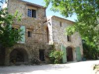 a large stone house with a balcony on the side at Le Mas Nomade in Callian