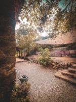 a view of a patio with an umbrella and chairs at Le Mas Nomade in Callian