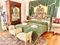 A bed or beds in a room at Palazzo Viola Suite Panoramica Palermo