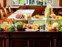 a table with plates of fruits and vegetables on it at Hotel Grand Tiara Minaminagoya in Anjo