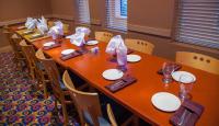 a long table with plates and napkins on it at iHOTEL & Conference Centre Red Deer in Red Deer