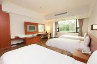 a hotel room with two beds and a desk at F Hotel - Chiayi in Fanlu