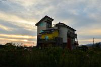 a building with a balcony on top of it at Fuluart B&amp;B in Dayin