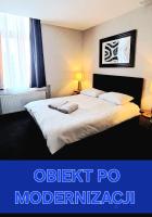 a bedroom with a large bed with a white bedspread at Villa Grudziądz in Grudziądz