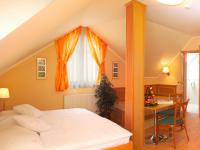 A bed or beds in a room at Vadászkürt Panzió