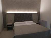 Posteľ alebo postele v izbe v ubytovaní Gabbiano Apartments