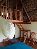 a room with a loft with a bed and a ladder at Soanala in Moramanga