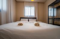Ein Bett oder Betten in einem Zimmer der Unterkunft Sun City - By Harim