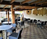 a restaurant with tables and chairs and tables and chairs at La Marie Galante Appart'Hotel in Saint-Georges-dʼOléron