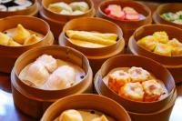 a group of bowls filled with different types of food at Seahouse Bali Indah Beach Inn in Kuta