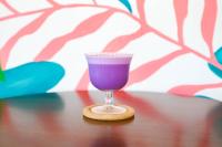 a glass of purple drink sitting on a table at Casa Mario's in Coron