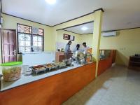 a group of people preparing food in a kitchen at Agung Homestay And Foodie in Kalawas