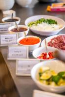 a bunch of bowls of food on a table at Ocean Bliss Hotel - Free Sauna in Da Nang