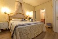 a bedroom with a large bed with a canopy at Residenza Goldoni in Venice
