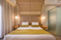 A bed or beds in a room at Agave Suites