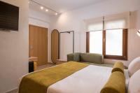 A bed or beds in a room at Agave Suites