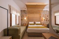 A bed or beds in a room at Agave Suites