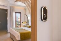 A bed or beds in a room at Agave Suites