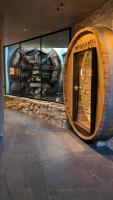 a room with a large wooden barrel in a museum at Mohe Boutique Hotel in Livigno