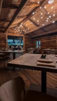 a dining room with tables and chairs and lights at Mohe Boutique Hotel in Livigno