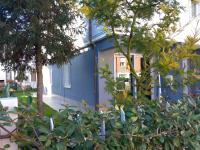 a blue building with trees in front of it at San Biagio in Ravenna
