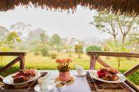 a table with two plates of food on it at Andasibe Sifaka Lodge in Andasibe
