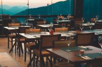 a dining room with tables and chairs with wine glasses at Caminho das Nuvens - Cabanas de Montanha in Bom Retiro