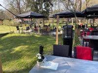 a table with flowers on it in a park at Wildthout Appartementen met Hotelservice in Ommen